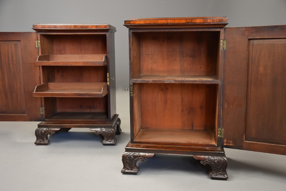 A pair of mid-18th-century mahogany Chippendale pedestal cabinets featuring relief-carved Rococo door panels, corner pilasters, and carved bracket feet. View X