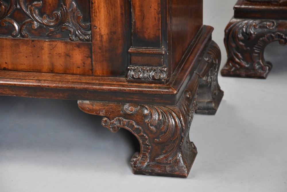 A pair of mid-18th-century mahogany Chippendale pedestal cabinets featuring relief-carved Rococo door panels, corner pilasters, and carved bracket feet. View XIII