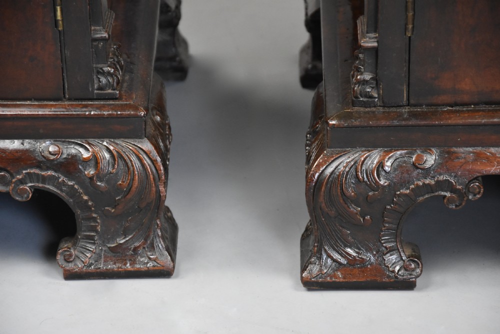 A pair of mid-18th-century mahogany Chippendale pedestal cabinets featuring relief-carved Rococo door panels, corner pilasters, and carved bracket feet. View XIV