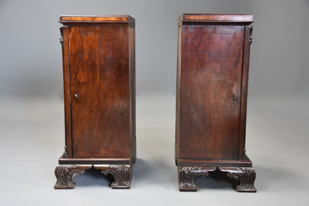 A pair of mid-18th-century mahogany Chippendale pedestal cabinets featuring relief-carved Rococo door panels, corner pilasters, and carved bracket feet. View XV