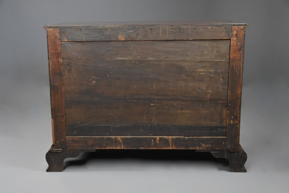 An 18th-century mahogany oxbow commode with four drawers, ornate brass bail handles, and prominent shaped feet. View XVI