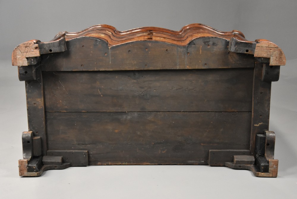 An 18th-century mahogany oxbow commode with four drawers, ornate brass bail handles, and prominent shaped feet. View XVII