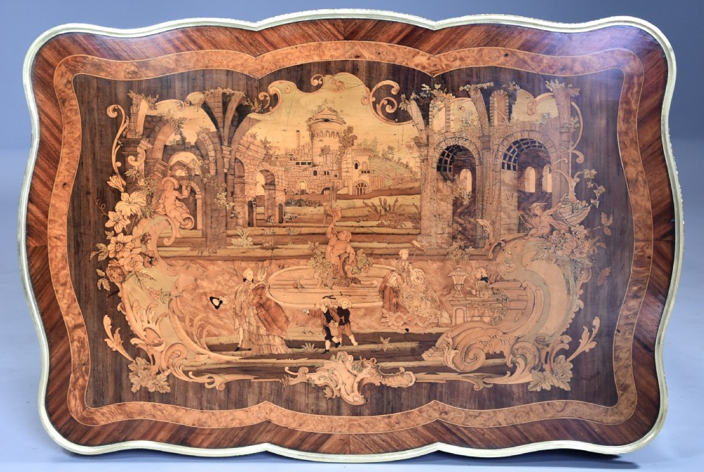 A mid-19th-century French Kingwood centre table featuring a serpentine top with intricate pictorial marquetry, cabriole legs, and ornate gilt-bronze mounts. View XII