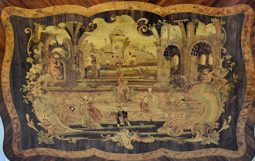 A mid-19th-century French Kingwood centre table featuring a serpentine top with intricate pictorial marquetry, cabriole legs, and ornate gilt-bronze mounts. View XIII