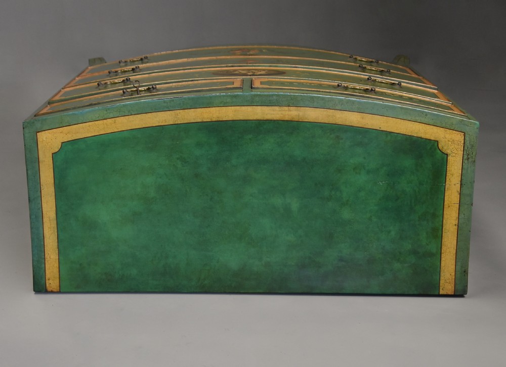 An early twentieth-century hand-painted green and gold bedroom suite featuring a wardrobe, chest of drawers with mirror, dressing desk, side tables, and caned chairs decorated with floral urn motifs. View XII