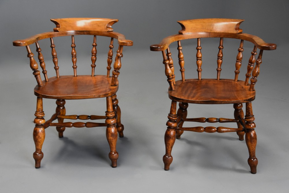 A pair of 19th-century birch smokers bow Windsor armchairs featuring steam-bent armrails, turned spindles, saddle seats, and turned legs with stretchers. View III