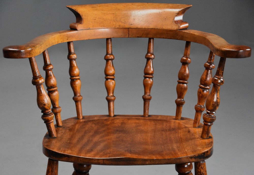 A pair of 19th-century birch smokers bow Windsor armchairs featuring steam-bent armrails, turned spindles, saddle seats, and turned legs with stretchers. View IV