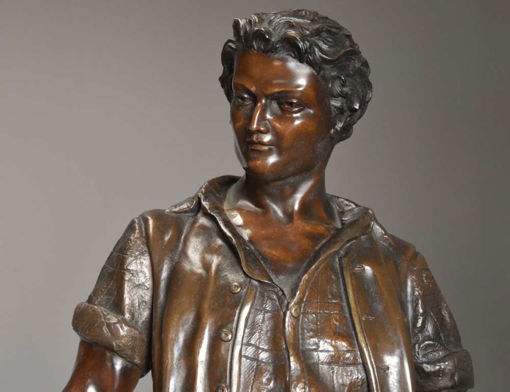 A late 19th-century French bronzed spelter figure depicting a barefoot male farm labourer holding a small bundle of wheat on a moulded base. View V