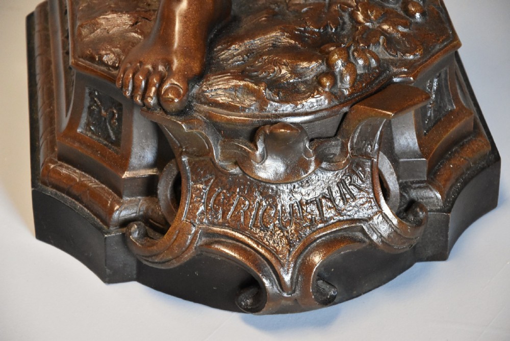 A late 19th-century French bronzed spelter figure depicting a barefoot male farm labourer holding a small bundle of wheat on a moulded base. View XII