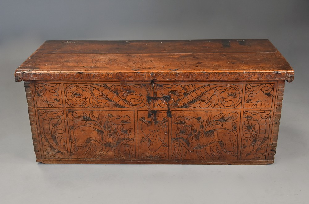 Early seventeenth-century Northern Italian cypress wood coffer decorated with detailed incised panels depicting mythical beasts and heraldic symbols. View II