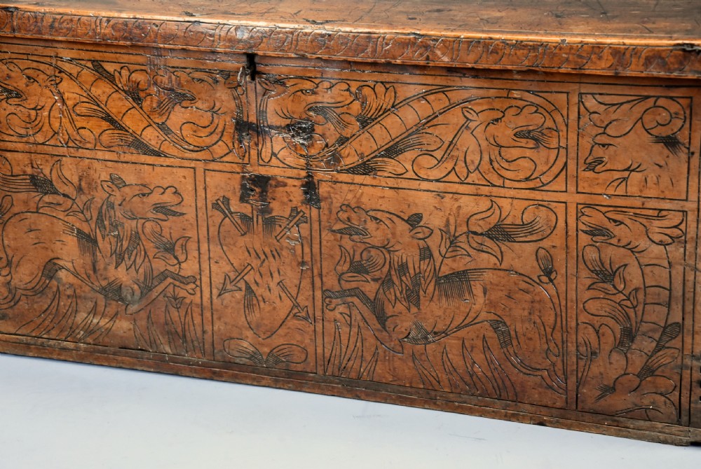 Early seventeenth-century Northern Italian cypress wood coffer decorated with detailed incised panels depicting mythical beasts and heraldic symbols. View V