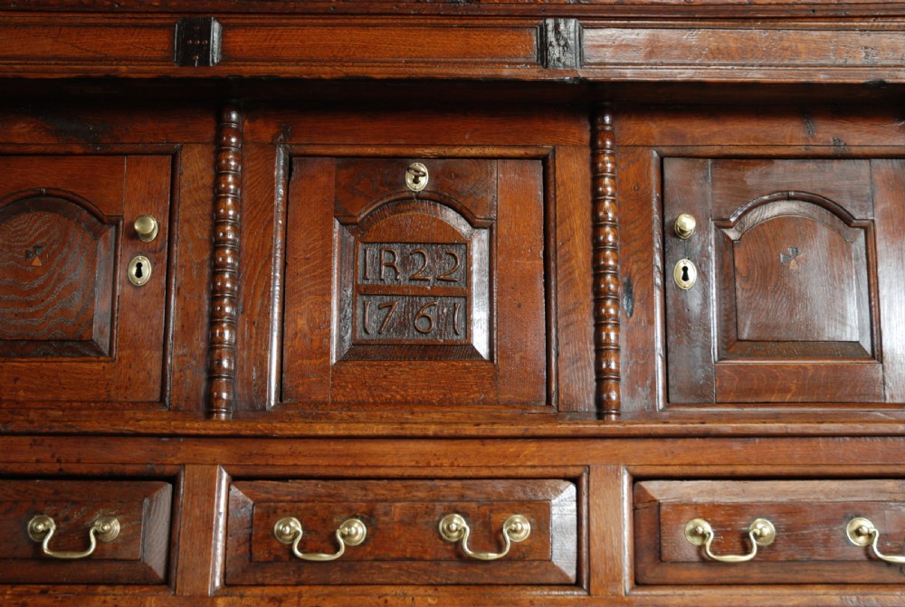 A mid-18th-century three-tier Welsh oak cwpwrdd tridarn featuring an open top canopy, carved panel dated 1761, turned pillars, and lower cupboards. View VIII