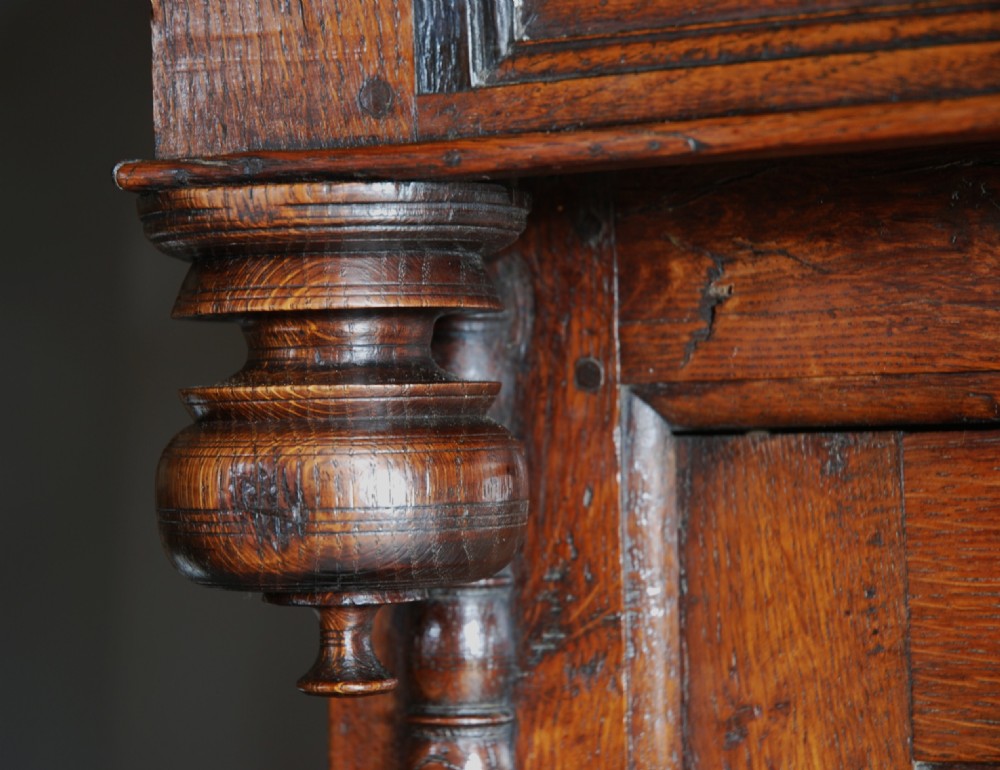 A mid-18th-century three-tier Welsh oak cwpwrdd tridarn featuring an open top canopy, carved panel dated 1761, turned pillars, and lower cupboards. View XI