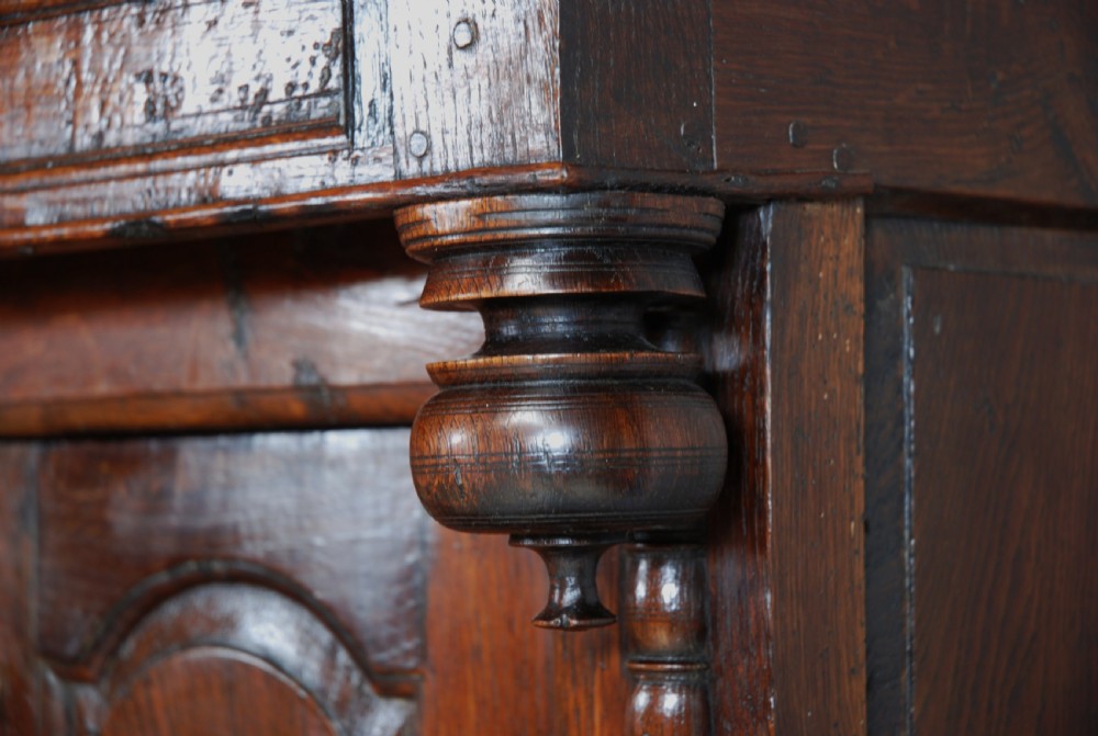 A mid-18th-century three-tier Welsh oak cwpwrdd tridarn featuring an open top canopy, carved panel dated 1761, turned pillars, and lower cupboards. View XII