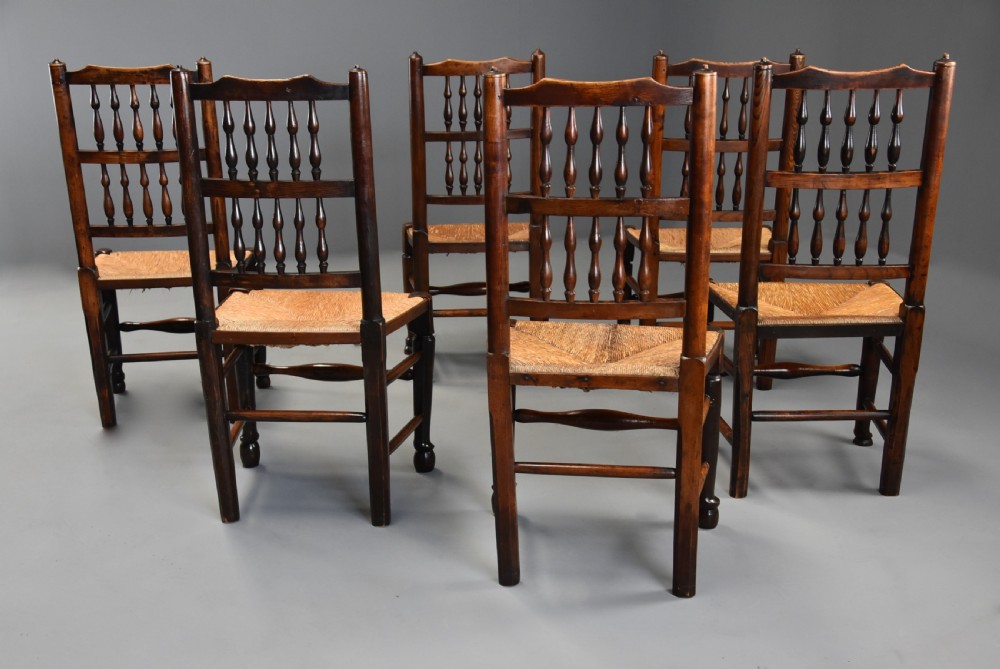 A set of six early nineteenth-century ash and elm spindle back dining chairs featuring woven rush seats and turned wooden stretchers. View VI