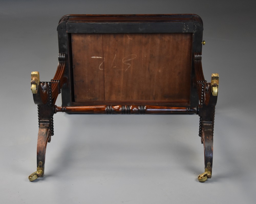 An early nineteenth-century rosewood occasional table featuring a rectangular top with a single drawer, scrolled trestle supports, beaded mouldings, and brass castors. View XVI