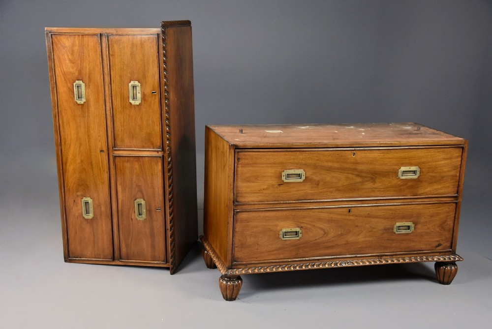 A late nineteenth-century padouk military chest of drawers featuring flush brass handles, carved rope-twist borders, and short fluted legs. View VIII