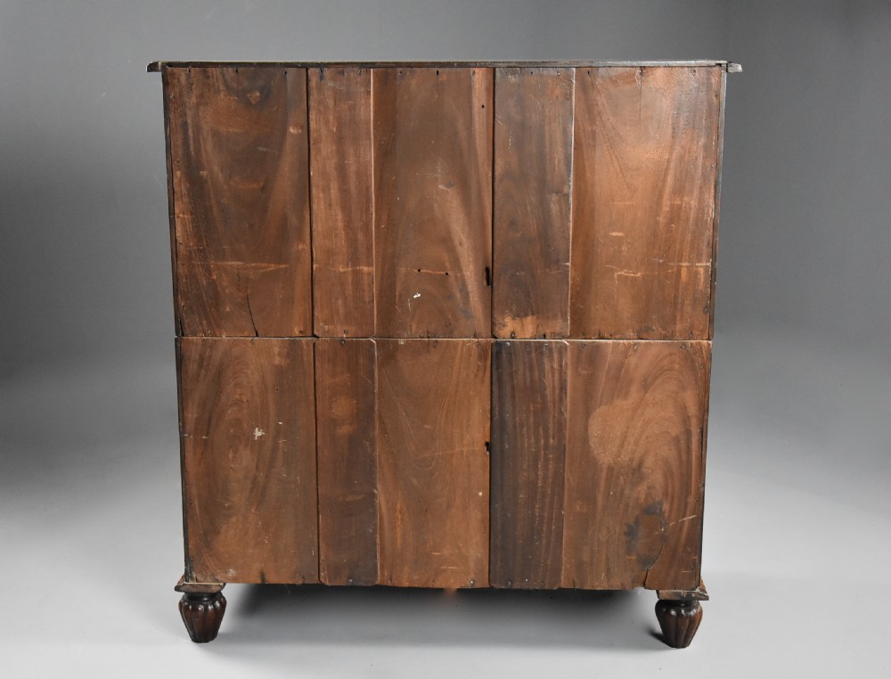 A late nineteenth-century padouk military chest of drawers featuring flush brass handles, carved rope-twist borders, and short fluted legs. View XI