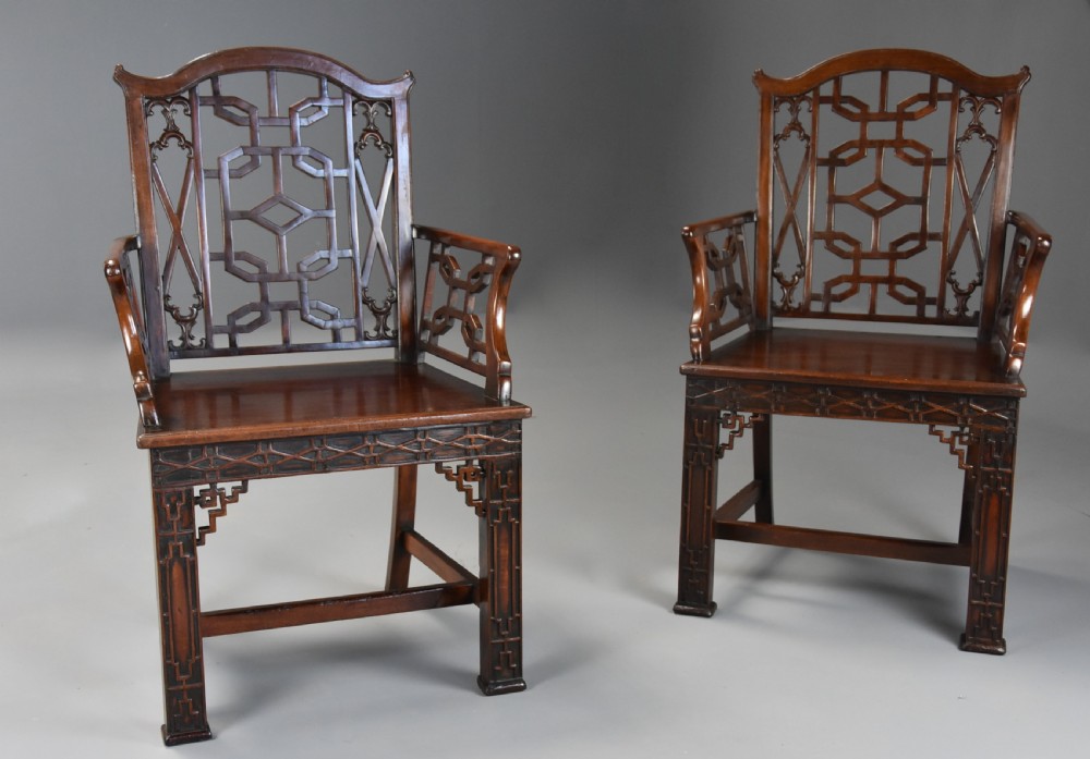 A pair of 18th-century mahogany open armchairs featuring intricate geometric Chinese lattice backrests, fretted arm supports, and carved straight legs. View IV