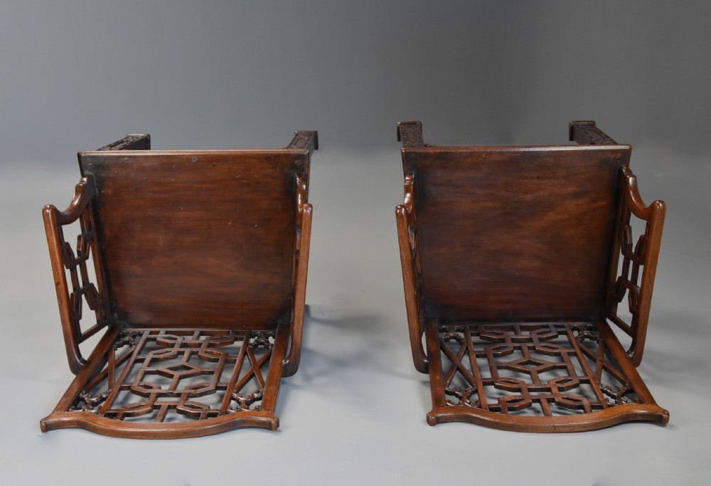 A pair of 18th-century mahogany open armchairs featuring intricate geometric Chinese lattice backrests, fretted arm supports, and carved straight legs. View XIV
