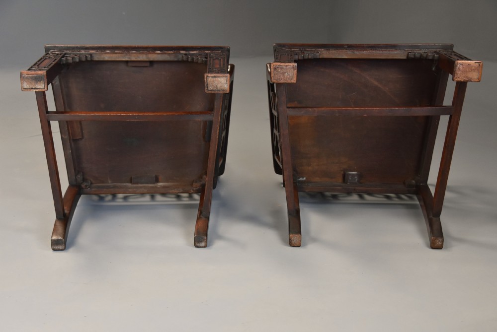 A pair of 18th-century mahogany open armchairs featuring intricate geometric Chinese lattice backrests, fretted arm supports, and carved straight legs. View XVI