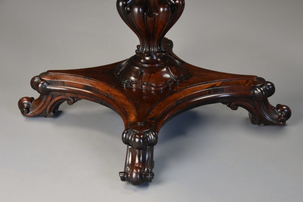 A mid-19th century rosewood games table featuring a square specimen marble inlaid chessboard top resting on a carved pedestal stem and scroll feet. View VIII