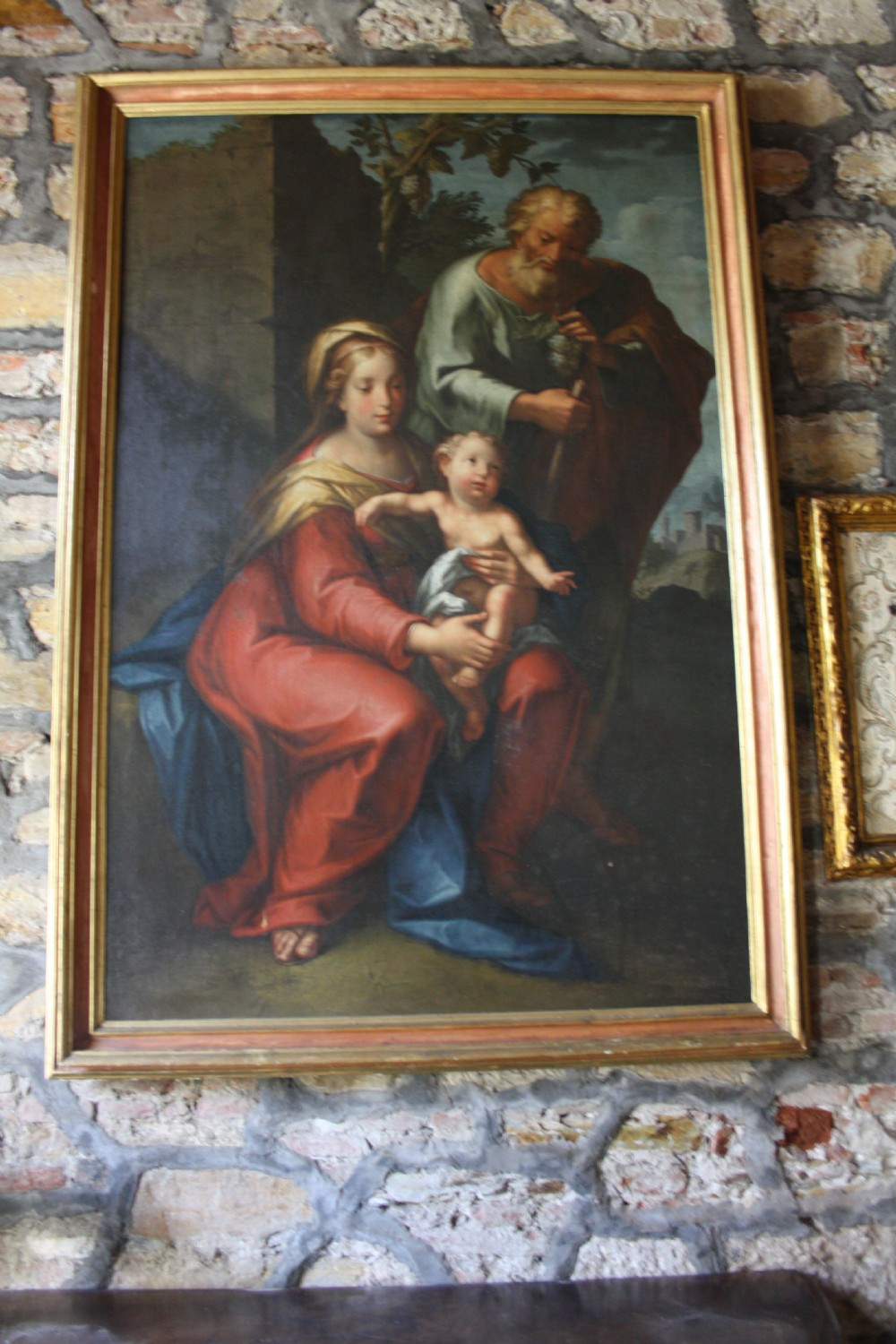 An 18th-century oil painting on canvas depicting the Holy Family set in a narrow gilded wooden frame. View II