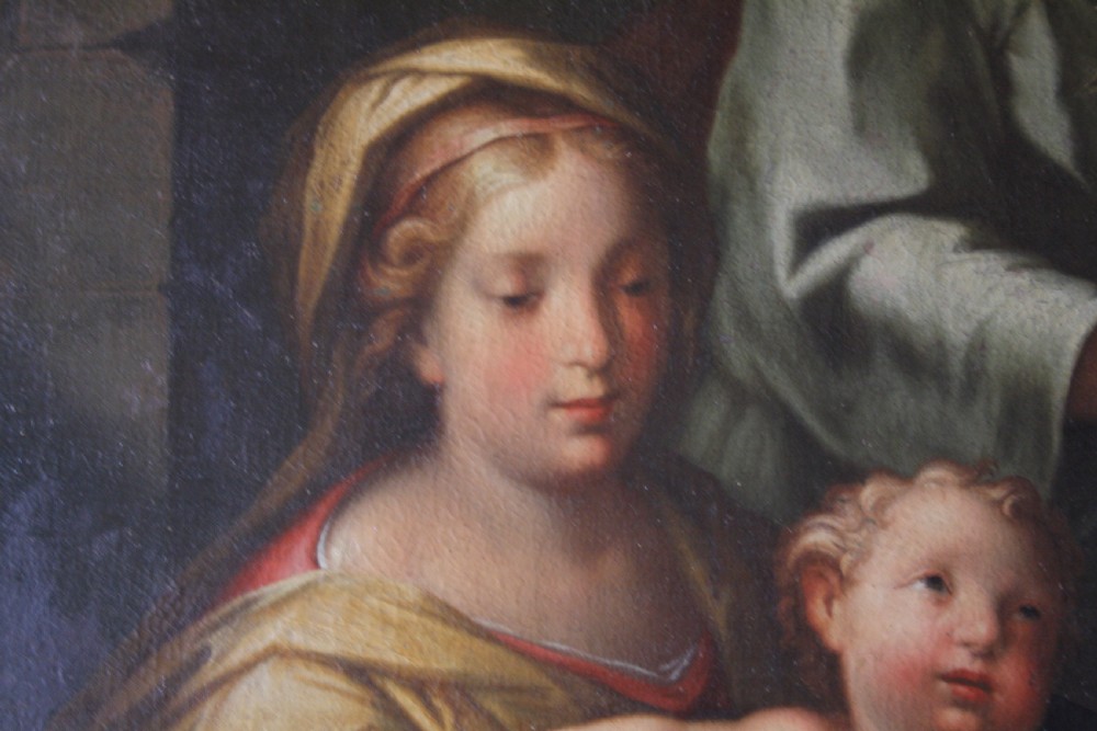 An 18th-century oil painting on canvas depicting the Holy Family set in a narrow gilded wooden frame. View IX
