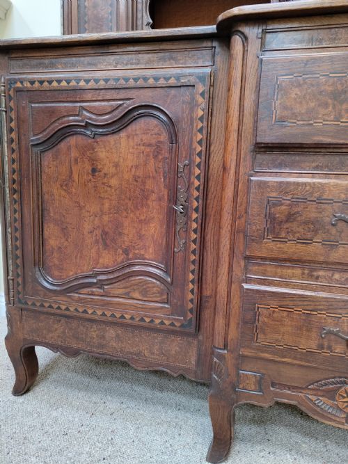 fig 3. A carved oak French provincial clock dresser featuring an integrated central longcase clock, open shelving, and a lower sideboard with drawers and cupboards.