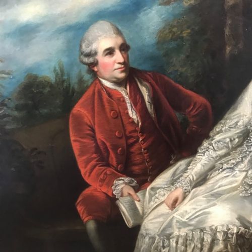 fig 2. An eighteenth-century style double oil portrait featuring a seated couple in period costume framed in an ornate gilded frame.