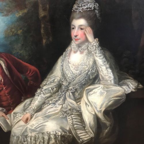 fig 6. An eighteenth-century style double oil portrait featuring a seated couple in period costume framed in an ornate gilded frame.