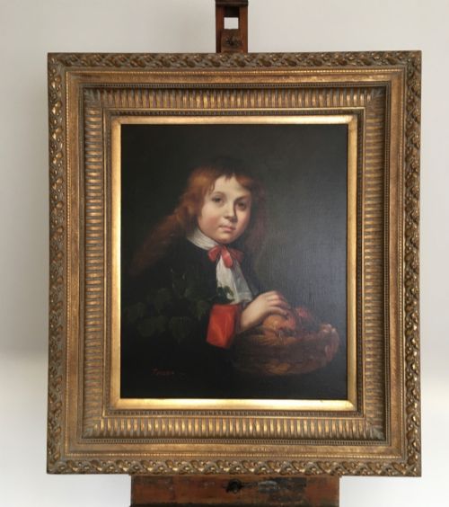 fig 5. A framed portrait of a young boy with reddish-brown hair holding a basket of fruit, set within an ornate gilded frame.