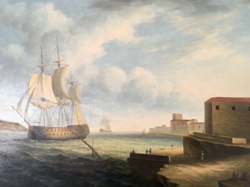 fig 1. A 19th-century style marine oil painting on panel depicting a large sailing warship anchored near a stone coastal fortification under a cloudy sky, presented in a heavily moulded gold gilt frame.