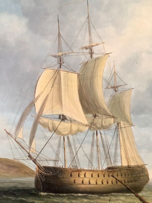 fig 5. A 19th-century style marine oil painting on panel depicting a large sailing warship anchored near a stone coastal fortification under a cloudy sky, presented in a heavily moulded gold gilt frame.