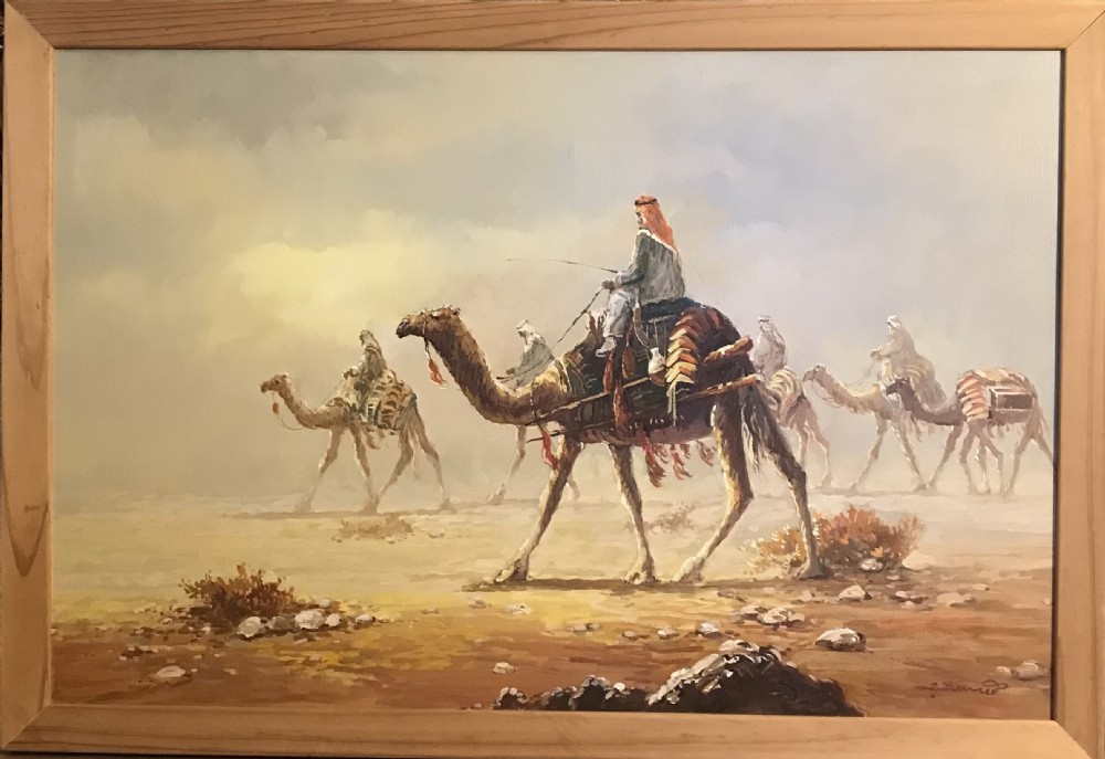 An oil painting on canvas depicting a Bedouin camel caravan traversing a desert landscape under a hazy sky, encased in a simple light wood frame. View XVI