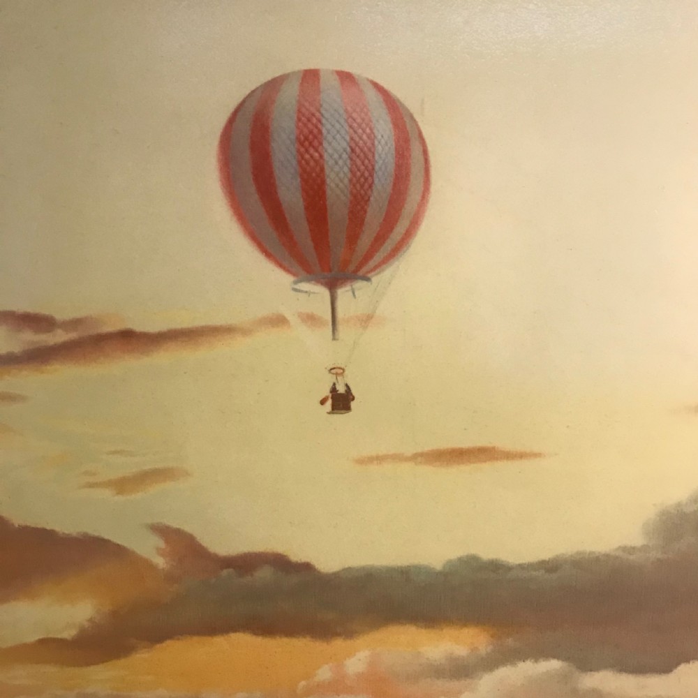 A large horizontal lithograph depicting a red and white striped hot air balloon floating above golden sunset clouds. View XII