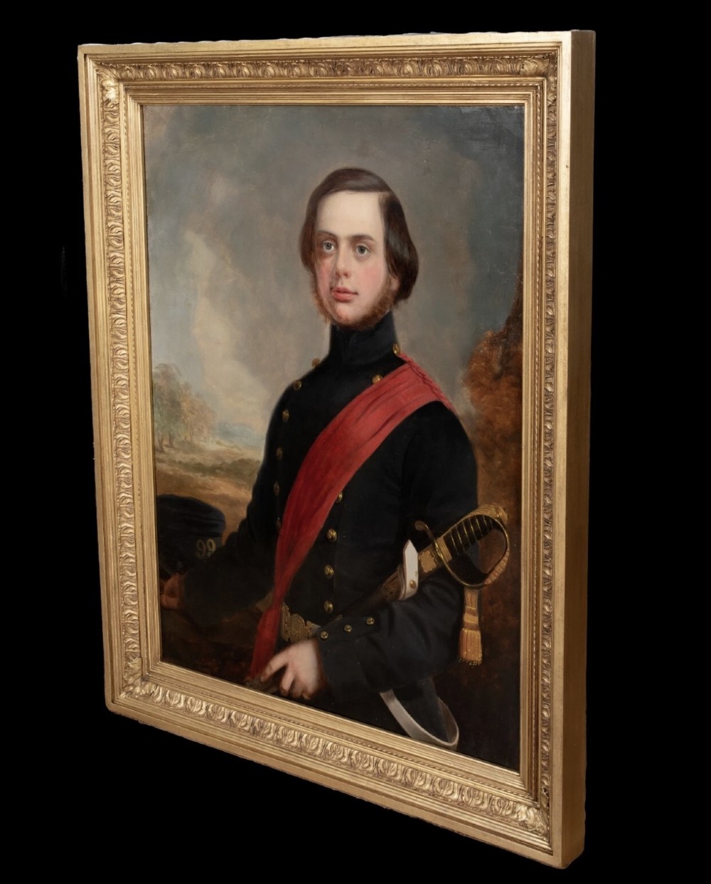 A nineteenth-century oil portrait on canvas depicting a British military officer in a dark tunic with a red sash, framed in an ornate gilt wood frame. View VII