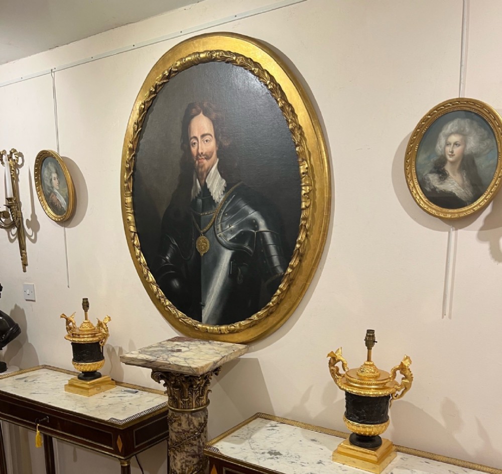 An eighteenth-century oval oil painting depicting King Charles I wearing plate armour and a lace collar within a gilded frame. View X