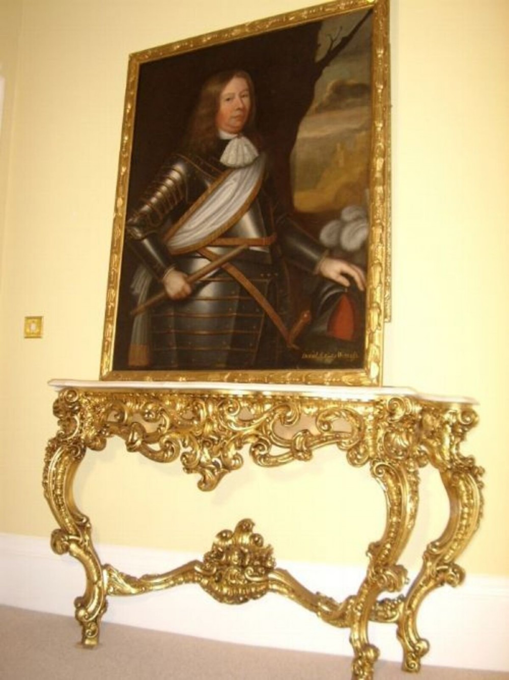 A seventeenth-century oil painting portraying a gentleman in plate armour with a lace cravat, set within an ornate gilded frame. View IV