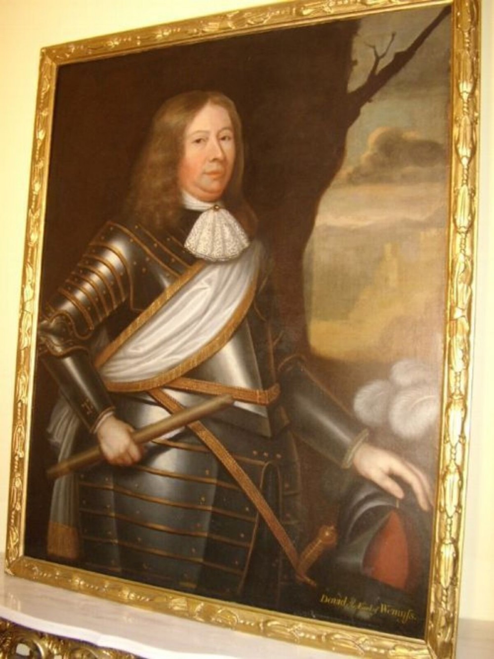 A seventeenth-century oil painting portraying a gentleman in plate armour with a lace cravat, set within an ornate gilded frame. View VIII