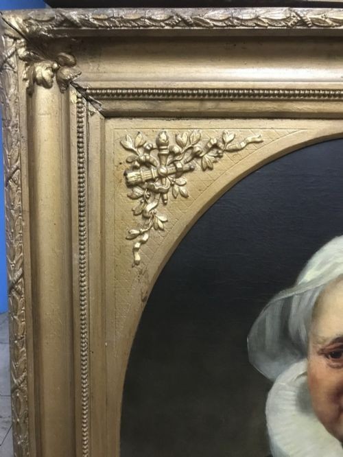 An 18th-century oil portrait of an elderly woman wearing a white bonnet and ruff collar, set inside an oval spandrel within a rectangular gilded frame. View V