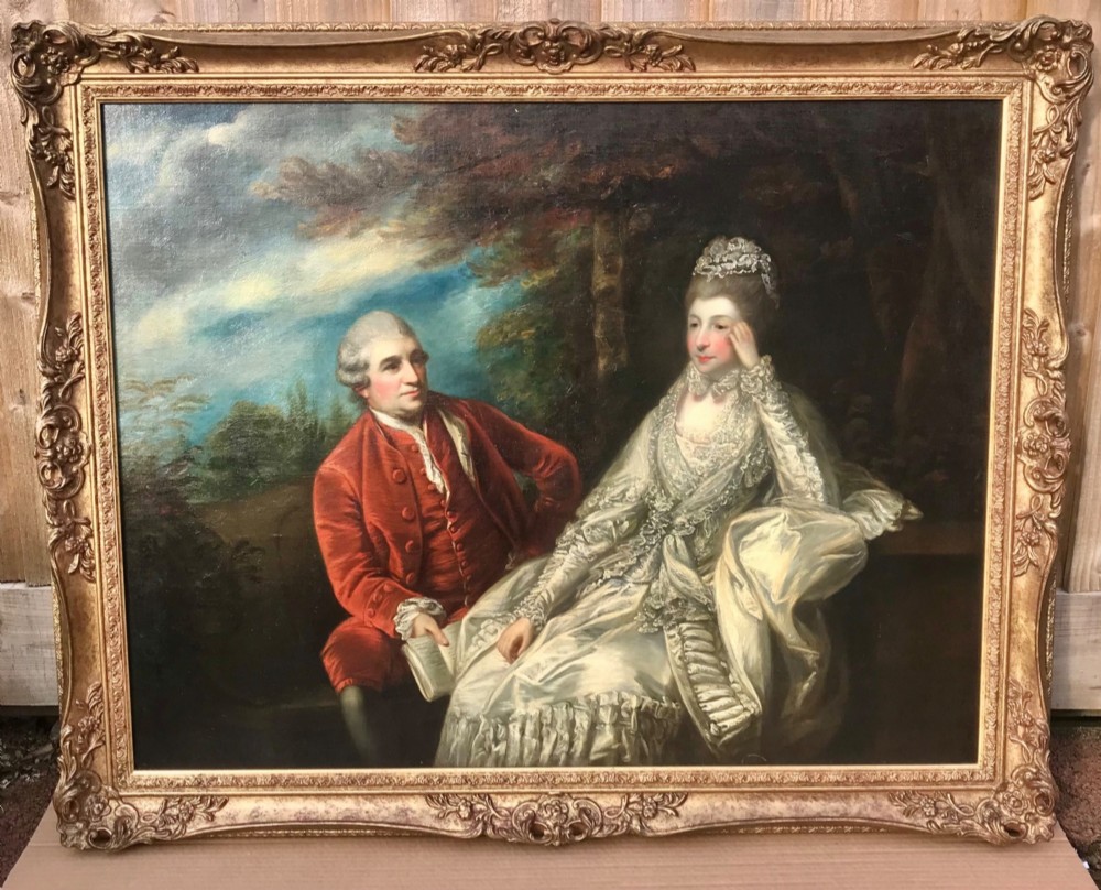 An 18th-century style oil painting depicting a seated man in a red velvet coat and a woman in an ivory gown, set in a carved gilt frame. View III