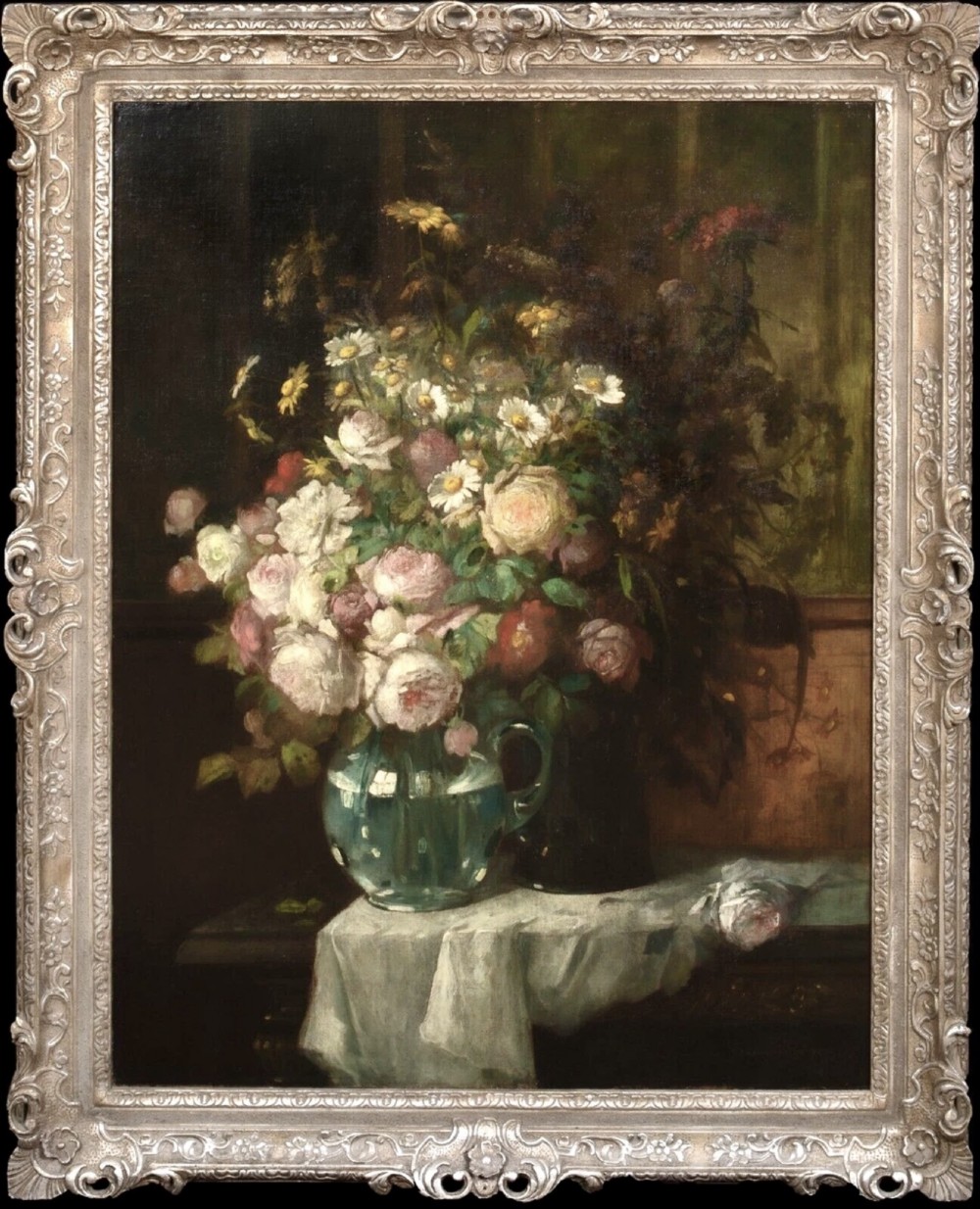 A 19th-century oil painting on canvas featuring a prominent vase of white and pink flowers on a draped tablecloth, set within an ornate silvered carved frame. View XII