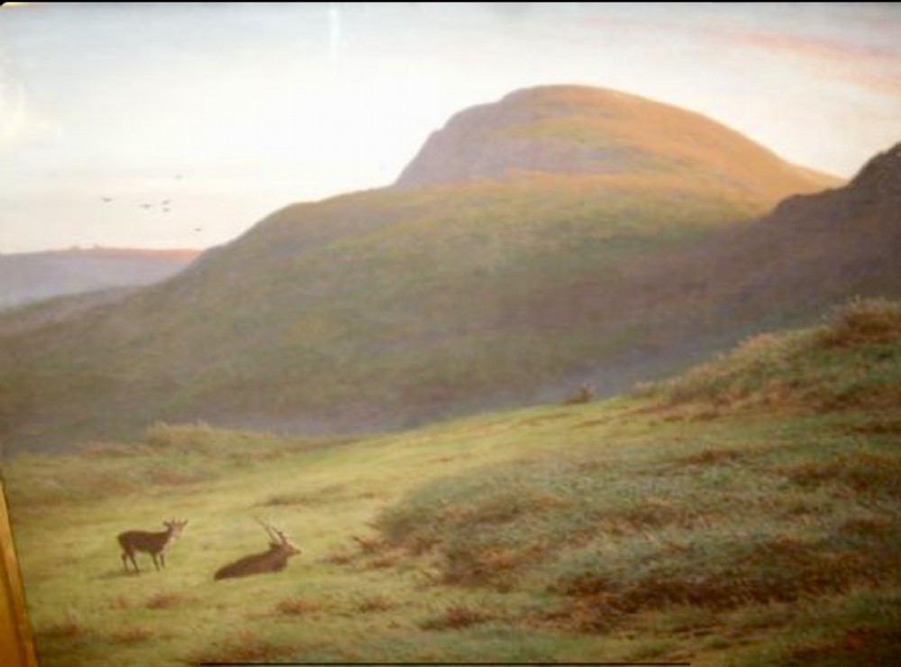A large framed landscape painting depicting rolling green hills and deer under a muted sky within a moulded gold gilt frame. View II