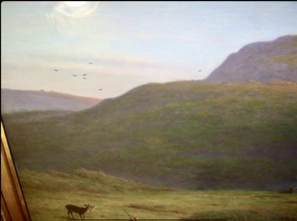 A large framed landscape painting depicting rolling green hills and deer under a muted sky within a moulded gold gilt frame. View IV