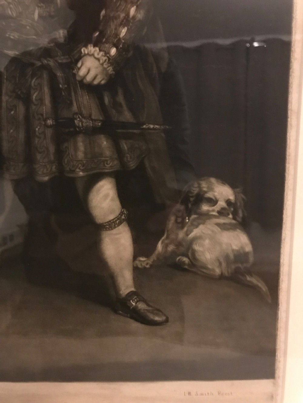 A framed black and white mezzotint print depicting a young boy in historical dress posing as Henry VIII. View XI