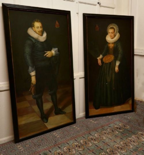 A pair of large framed full-length oil portraits depicting a man and woman in 17th-century Dutch attire with white ruff collars. View VII