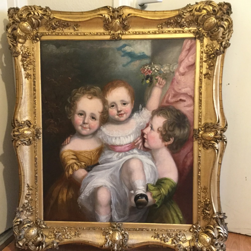 A 19th-century oil portrait of three children in classical attire contained within a carved swept giltwood frame. View VIII