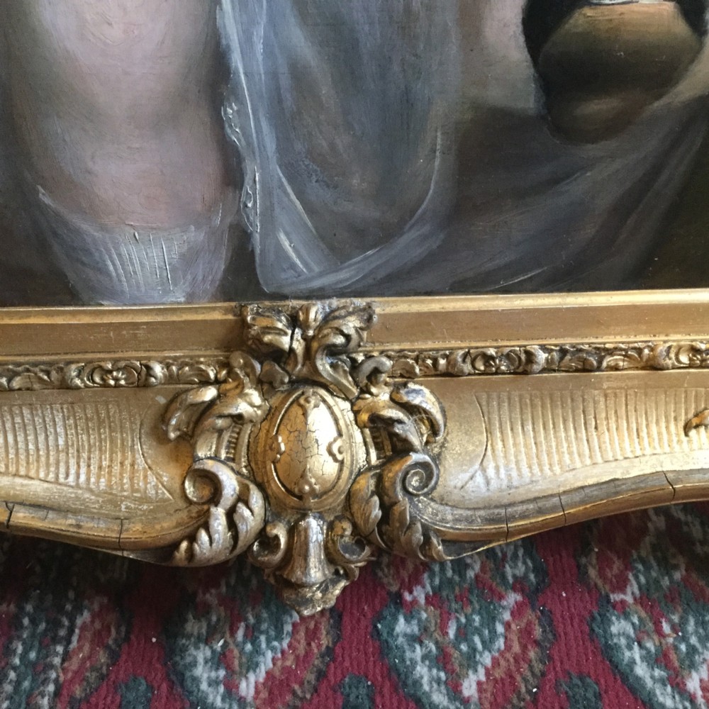 A 19th-century oil portrait of three children in classical attire contained within a carved swept giltwood frame. View IX