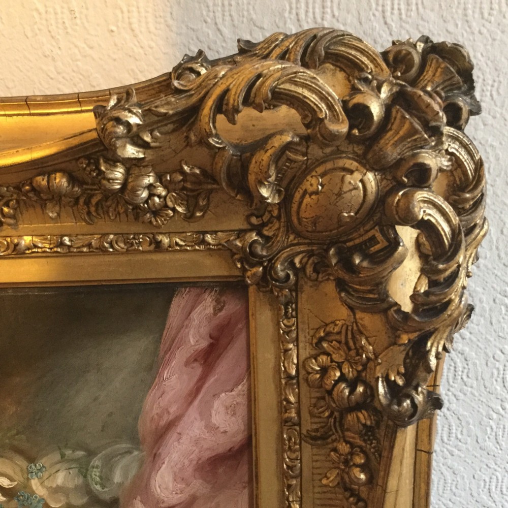 A 19th-century oil portrait of three children in classical attire contained within a carved swept giltwood frame. View XI